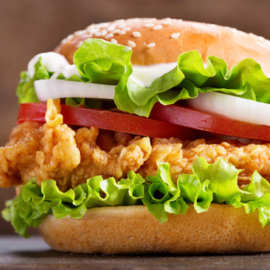 Fried chicken sandwich on a bun showing batters and breadings in texturizer applications.