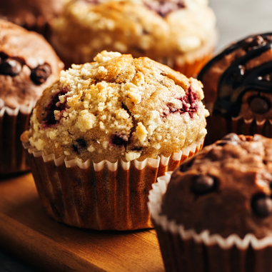 A group of muffins on a wooden surface showing multi-benefit dietary fibers as a texturizer type.