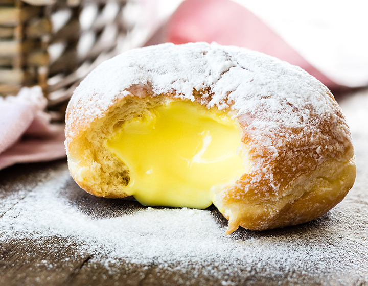 Custard filled donut with icing sugar