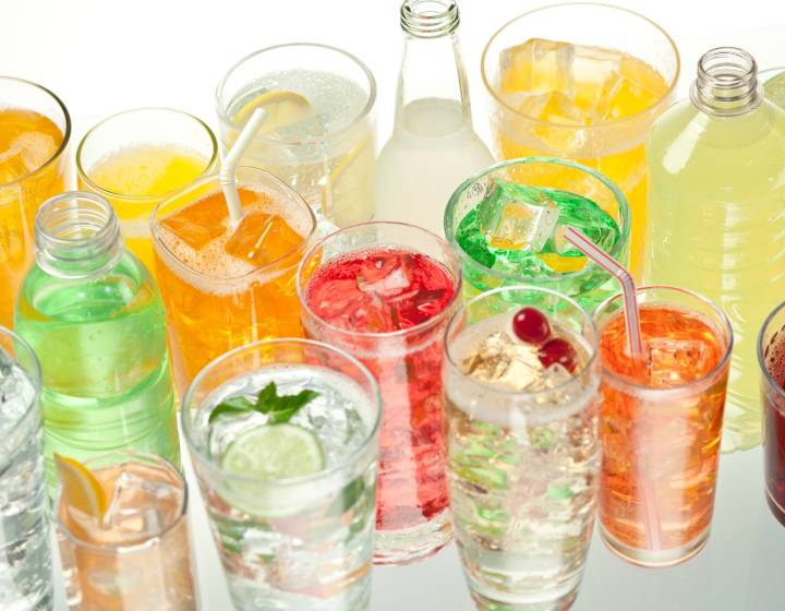 Variety of different coloured beverages and bottles