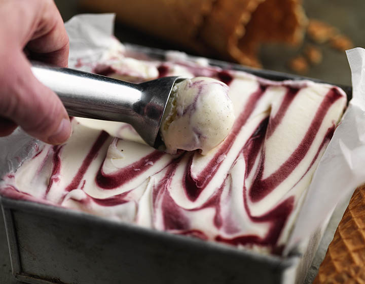 Taking a scoop out of raspberry ripple ice cream