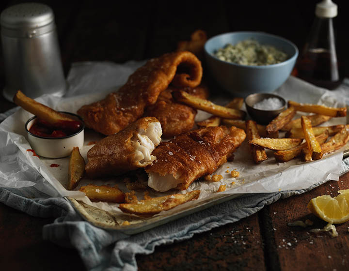 Battered fish and chips with ketchup and tartar sauce
