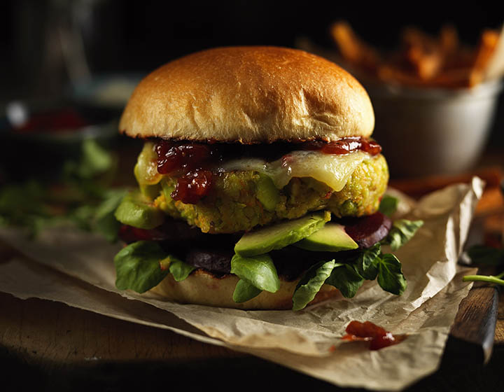 Bean burger on a bun with avocado and sauce