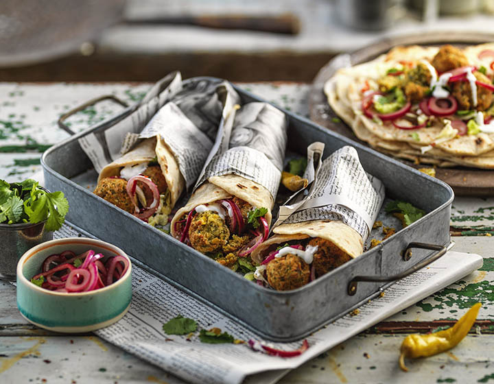 Falafel flatbreads with red onion garnishes