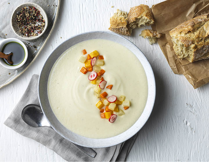 Celeriac veloute with a vegetable garnish and bread