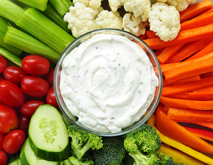 A selection of fresh vegetables with a creamy dip