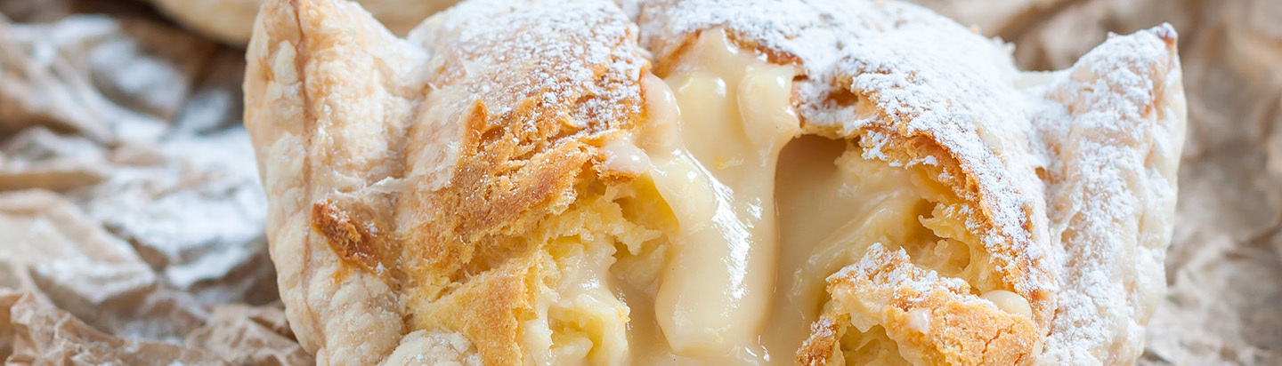 A baked sweet pastry with thick cream filling