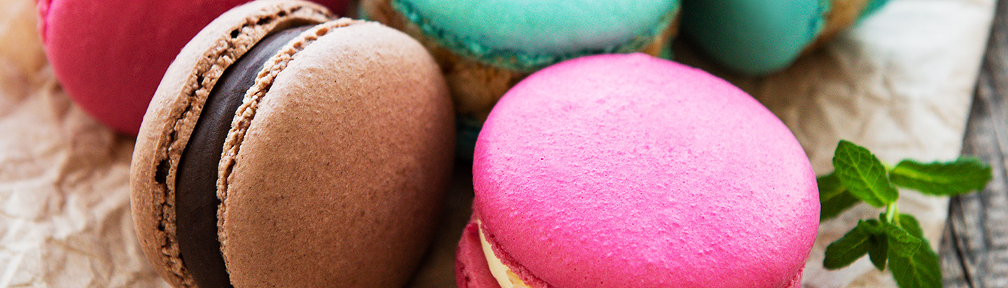 Colorful macaroons and mint  on a old wooden  background