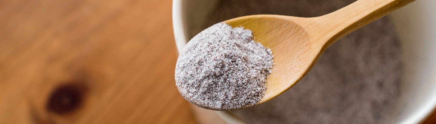 Hot chocolate powder on a wooden spoon