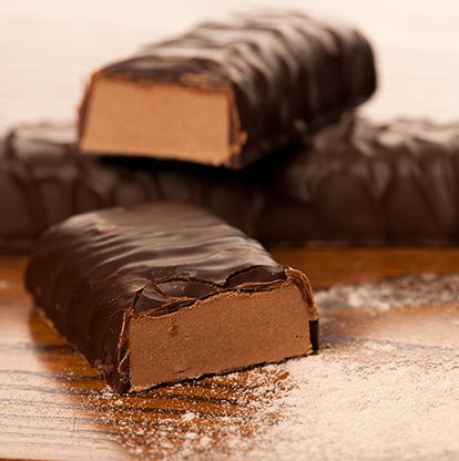 Chocolate covered protein bar cut in half