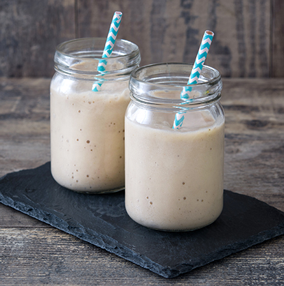 Two jars of protein shake with blue striped straws