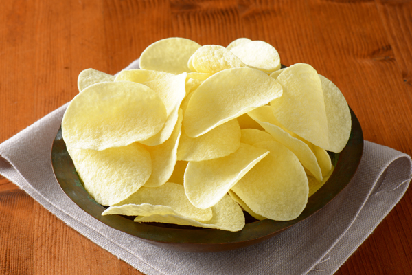 Bowl of thin salted potato chips (crisps)