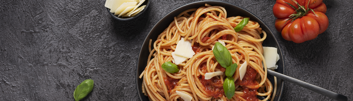 Bowl of clean label pasta with tomato and basil