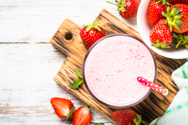 Strawberry smoothie or milkshake. Top view with fresh berries.