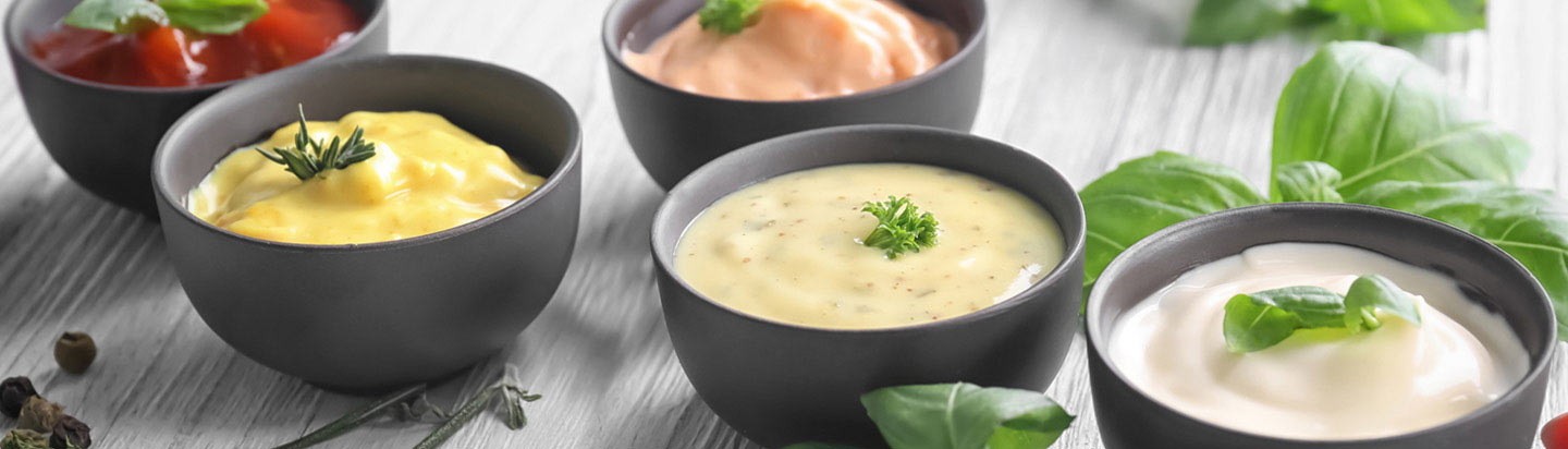 Bowls of clean and simple condiments with garnishes