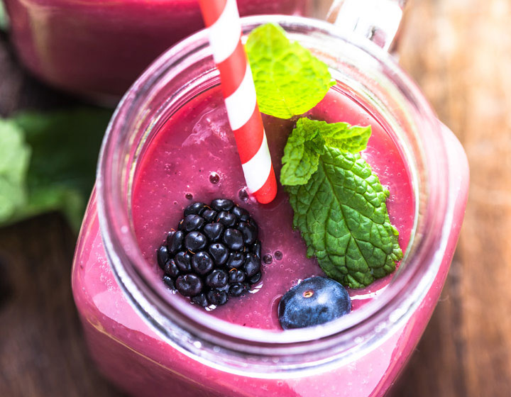 Clean and simple yogurt smoothie with berries and straw
