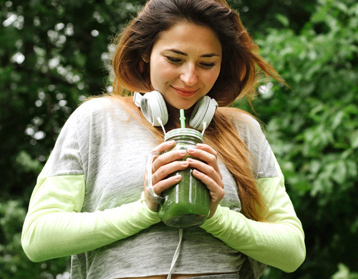 Woman with healthy drink in jar