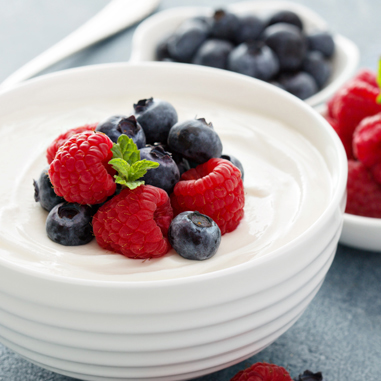 Yogurt with berries on top in a white bowl showing functional native starches as a texturizer type.