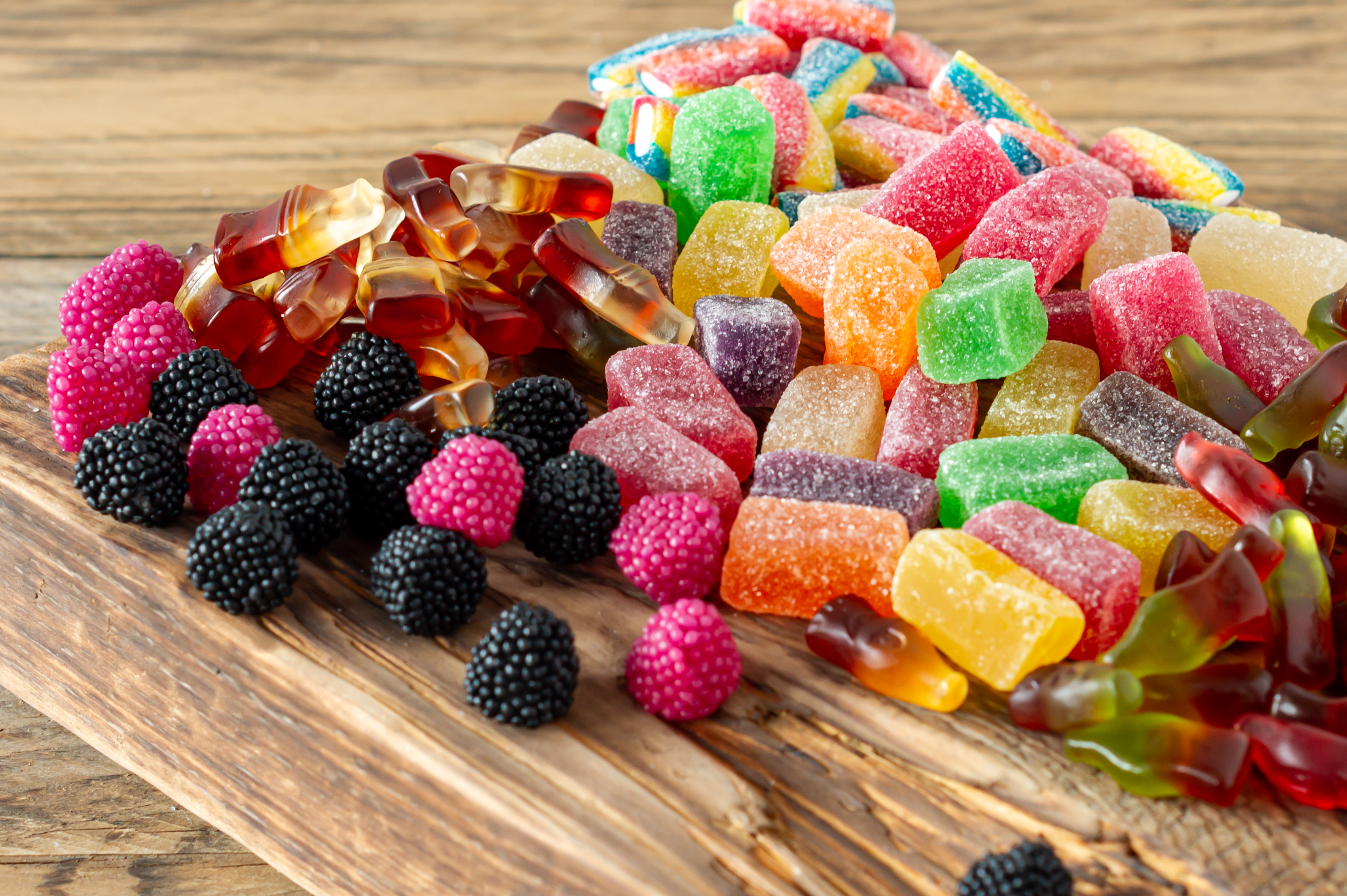 Fruit marmalade sweets, jelly candies on a wooden desk. Fruit natural dessert with sugar.