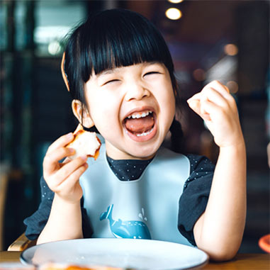Young girl enjoying a meal