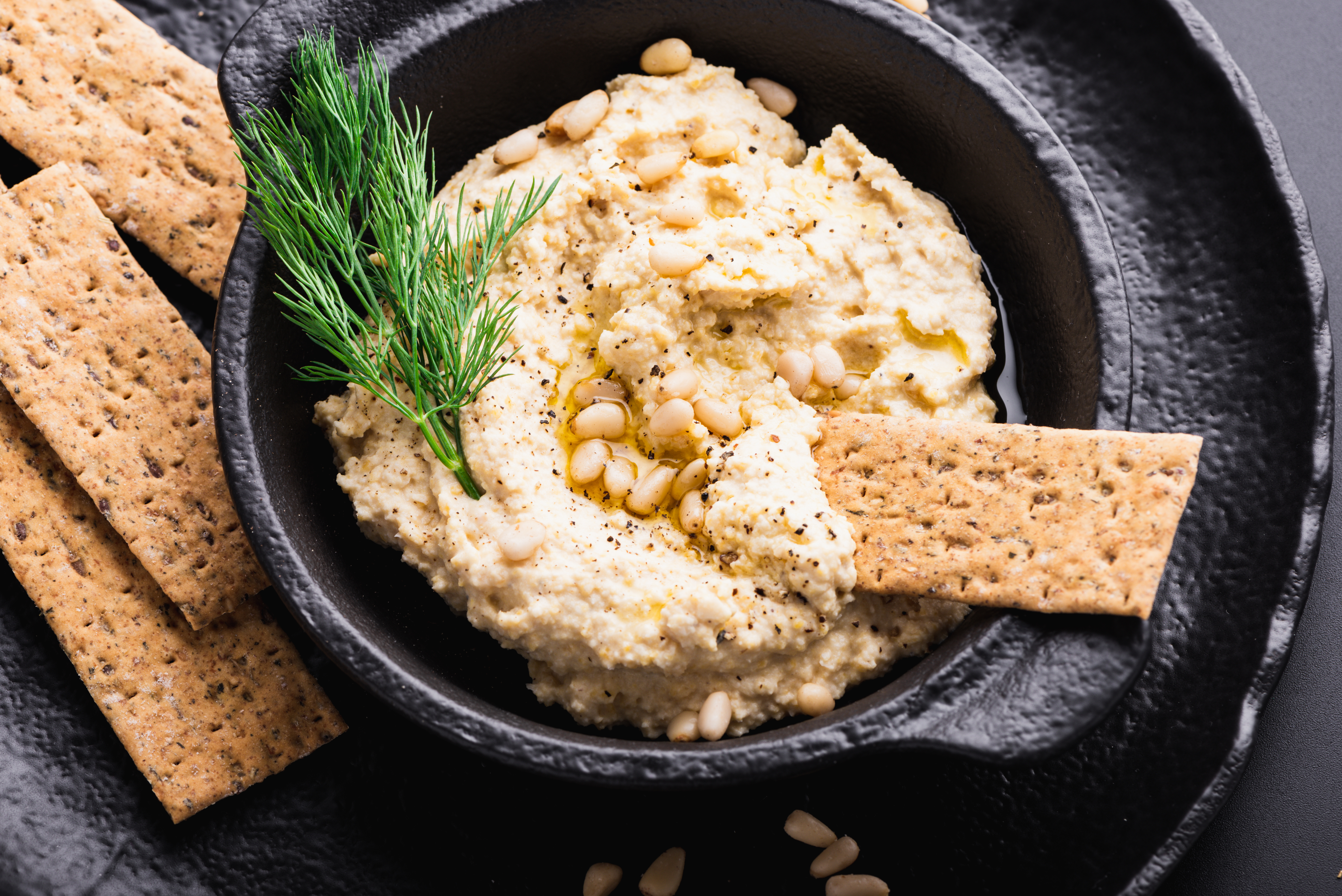 Fresh homemade hummus with vegan crackers