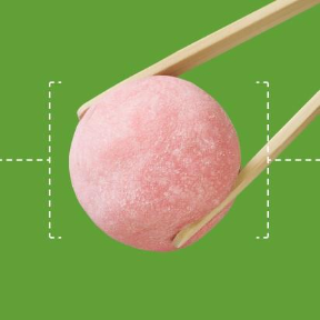 Close-up of a pink mochi dessert held by chopsticks against a green background, showcasing its soft, chewy texture
