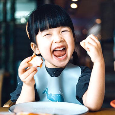 Young girl enjoying a meal